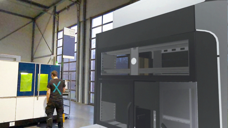 Durch die Mixed-Reality-Brille wird die Maschinenverkleidung für die Indunorm Bewegungstechnik GmbH digital visualisiert und nahtlos in die Produktionshalle eingebettet.